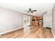 Spacious living area featuring wood floors, a ceiling fan, and a convenient kitchen access at 12527 Trester Ln, Fishers, IN 46038