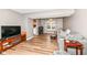 Comfortable living room featuring hardwood floors, neutral walls, and a view of the kitchen at 12527 Trester Ln, Fishers, IN 46038