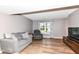 Spacious living room features hardwood floors, comfortable seating arrangements, and bright natural light at 12527 Trester Ln, Fishers, IN 46038