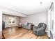 Relaxing living room with hardwood flooring, a comfortable sofa, recliner, and natural light at 12527 Trester Ln, Fishers, IN 46038