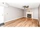 Cozy living room with fireplace, wood floors, and door to the outside at 12527 Trester Ln, Fishers, IN 46038