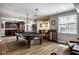 Finished basement area featuring a pool table, wine rack, and bar area with custom lighting fixtures at 12897 Queens Troop, Carmel, IN 46032