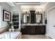 Luxurious bathroom with double vanity, dark cabinetry, and a soaking tub at 12897 Queens Troop, Carmel, IN 46032