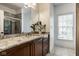 Bathroom featuring dual sinks with granite counters and a tiled shower with glass door at 12897 Queens Troop, Carmel, IN 46032