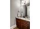 Elegant bathroom vanity with granite countertop, dark wood cabinets, and a large mirror at 12897 Queens Troop, Carmel, IN 46032