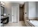 Spa-like bathroom featuring a soaking tub, walk-in shower, and vanity area at 12897 Queens Troop, Carmel, IN 46032
