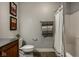 Bathroom featuring a toilet, shower/tub combo with a decorative shower curtain and updated fixtures at 12897 Queens Troop, Carmel, IN 46032