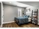 Cozy bedroom with a window, ladder shelf, and plaid comforter at 12897 Queens Troop, Carmel, IN 46032