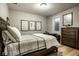 Comfortable bedroom with a bed, desk, dresser, and natural light from a window at 12897 Queens Troop, Carmel, IN 46032
