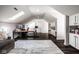 Spacious bonus room with a skylight, dark wood floors and custom built-in shelving for ample storage at 12897 Queens Troop, Carmel, IN 46032