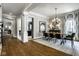 Open-concept dining room with neutral decor, modern lighting, and hardwood floors at 12897 Queens Troop, Carmel, IN 46032