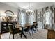 Well-lit dining room featuring stylish decor, designer lighting, and hardwood floors at 12897 Queens Troop, Carmel, IN 46032