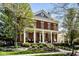 Beautiful brick home featuring a large front porch with columns and professional landscaping at 12897 Queens Troop, Carmel, IN 46032