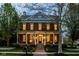 Charming two-story brick home with a welcoming front porch, columns, and landscaped front yard at 12897 Queens Troop, Carmel, IN 46032