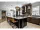 Modern kitchen with granite counters, large island, stainless steel appliances, and pendant lighting at 12897 Queens Troop, Carmel, IN 46032