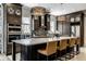A view of a modern kitchen with dark wood cabinets, stainless steel appliances, and granite counters at 12897 Queens Troop, Carmel, IN 46032