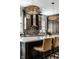 A modern kitchen with an island, stainless appliances, mosaic backsplash and designer lighting at 12897 Queens Troop, Carmel, IN 46032
