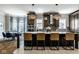 Modern kitchen with a large island with seating, stainless steel appliances, and decorative lighting at 12897 Queens Troop, Carmel, IN 46032
