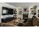 Comfortable living room featuring a fireplace, custom built-ins, and a large screen television at 12897 Queens Troop, Carmel, IN 46032
