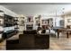 Open-concept living room featuring a cozy fireplace, built-in bookshelves, and a pool table at 12897 Queens Troop, Carmel, IN 46032