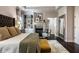 Comfortable main bedroom with a fireplace, seating, decorative accents, and a walk-in closet at 12897 Queens Troop, Carmel, IN 46032