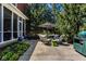Relaxing patio area with an umbrella, outdoor seating, and a grill, surrounded by lush greenery at 12897 Queens Troop, Carmel, IN 46032