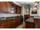 Close-up of the basement wet bar with dark wood cabinetry, sink, mini-fridge and plenty of storage at 12897 Queens Troop, Carmel, IN 46032