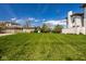 Spacious grassy yard with view of well-maintained homes in a quiet neighborhood, bathed in sunlight at 12897 Queens Troop, Carmel, IN 46032