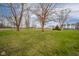 Vast open lawn with mature trees at 140 Kim Dr, Anderson, IN 46012