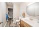 Bathroom features a wood vanity, round mirror, and neutral wall color creating a comfortable atmosphere at 140 Kim Dr, Anderson, IN 46012