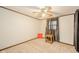 Bright bedroom with beige carpet, ceiling fan, and large window with natural light at 140 Kim Dr, Anderson, IN 46012