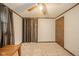 Bedroom with beige carpet, ceiling fan, and dark colored trim creating a calm atmosphere at 140 Kim Dr, Anderson, IN 46012