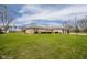 Well-maintained ranch-style home on a large green lot with mature trees and an attached garage at 140 Kim Dr, Anderson, IN 46012