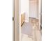 Hallway that leads to the bathroom featuring an oak vanity and a closet at 140 Kim Dr, Anderson, IN 46012