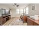 Bright home office with hardwood floors, white brick, ceiling fan and natural lighting at 140 Kim Dr, Anderson, IN 46012