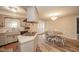 The open kitchen and dining area features an island cooktop and classic cabinets at 140 Kim Dr, Anderson, IN 46012