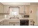 This classic kitchen is complete with stainless steel appliances and a bright window at 140 Kim Dr, Anderson, IN 46012