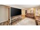 A cozy living room shows a large TV with a comfortable leather sofa at 140 Kim Dr, Anderson, IN 46012