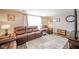 Comfortable living room featuring a plush leather sofa, armchairs, and a stylish area rug at 140 Kim Dr, Anderson, IN 46012