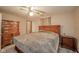 Warm bedroom includes a ceiling fan, carpet, and matching wooden furniture at 140 Kim Dr, Anderson, IN 46012