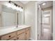 Bathroom with a spacious vanity, ample storage, a decorative mirror, and modern lighting fixtures at 1561 Brookfield Cir, Franklin, IN 46131