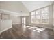 Bright living room with hardwood floors, large windows, and a vaulted ceiling at 1561 Brookfield Cir, Franklin, IN 46131