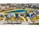 Aerial view of a residential area showcasing luxury homes surrounding a scenic pond and landscaping at 16129 Brookhollow Dr, Westfield, IN 46062