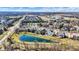 High angle aerial view of a neighborhood with scenic pond views, well-manicured lawns, and nearby amenities creating an idyllic setting at 16129 Brookhollow Dr, Westfield, IN 46062