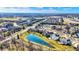 An aerial view highlighting a community with ponds and tree-lined streets showcasing a desirable residential area at 16129 Brookhollow Dr, Westfield, IN 46062