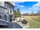 Backyard area featuring stone patio, fire pit, and stairs to an elevated deck at 16129 Brookhollow Dr, Westfield, IN 46062