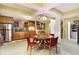 Basement bar area with wood cabinets, stainless steel refrigerator, and coffered ceilings at 16129 Brookhollow Dr, Westfield, IN 46062