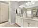 Bright bathroom boasts tile floors, double vanity, tub, and separate glass enclosed shower at 16129 Brookhollow Dr, Westfield, IN 46062