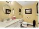 Cozy half bathroom with framed mirror, vanity sink, and decorative framed art at 16129 Brookhollow Dr, Westfield, IN 46062