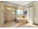 This bathroom features tile floors, tub, and separate glass enclosed shower and storage cabinet at 16129 Brookhollow Dr, Westfield, IN 46062